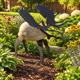 Garden setting – Moose sculpture displayed among plants and flowers in a backyard garden