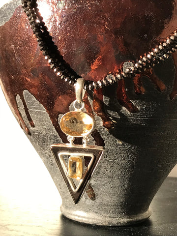 Citrine in triangular style pendant on brown crystal strand